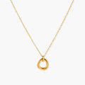 Delicate gold-plated necklace with three interlocking circle rings forming a minimalist knot pendant on cream background