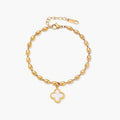 18K gold-plated oval bead bracelet with a four-leaf clover charm in mother-of-pearl or black enamel, adjustable lobster clasp, on white background.