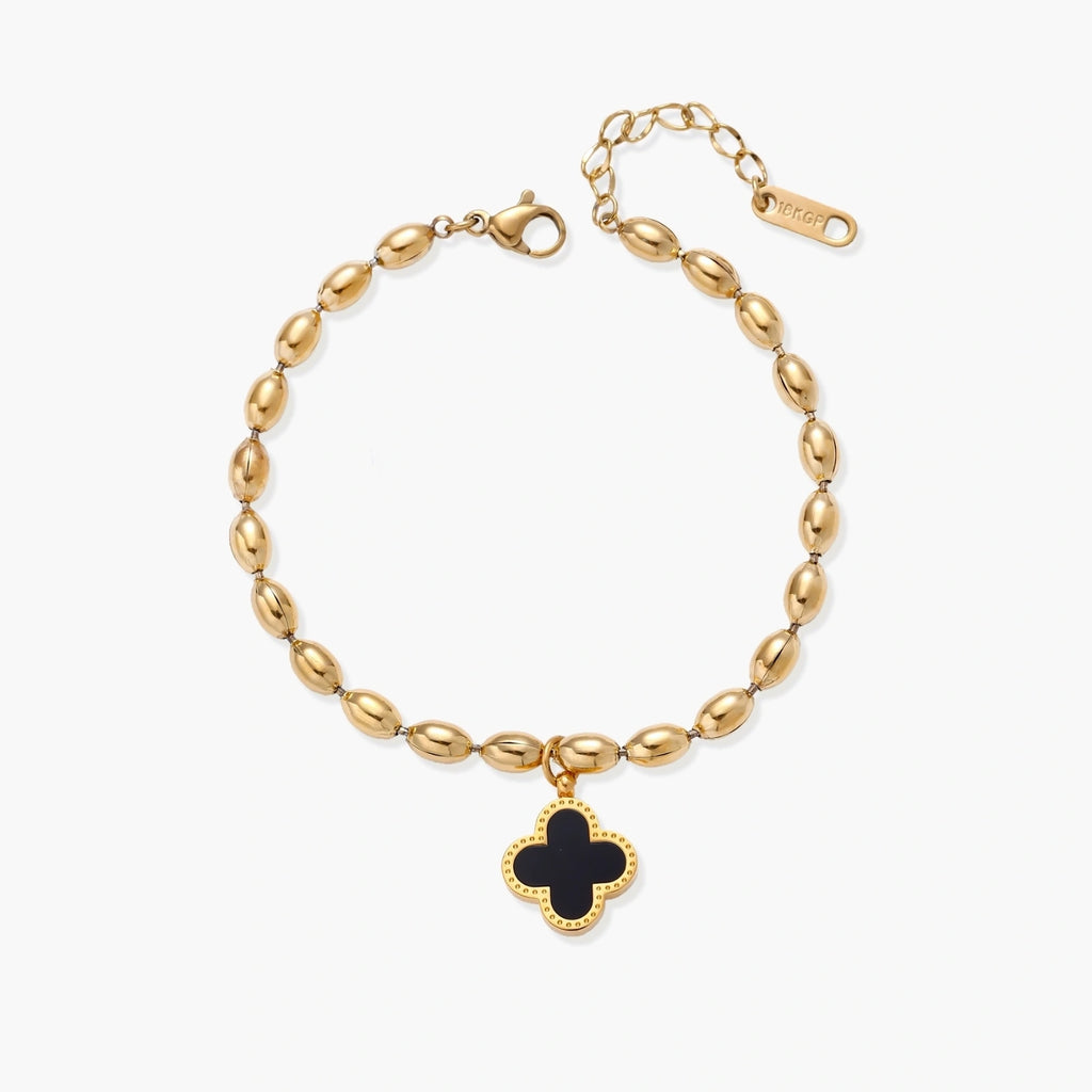 18K gold-plated oval bead bracelet with a four-leaf clover charm in mother-of-pearl or black enamel, adjustable lobster clasp, on white background.