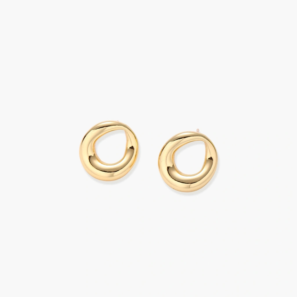 Pair of polished 18K gold-plated stainless steel teardrop earrings with hollow centers on cream background