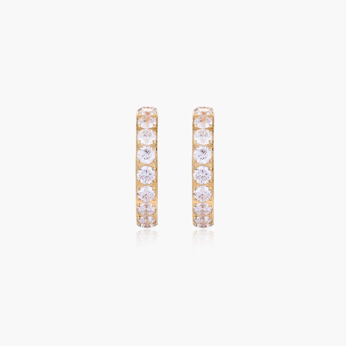 Gold pavé hoop earrings with two freshwater pearls nestled inside the curved design, featuring crystal-studded outer edge.