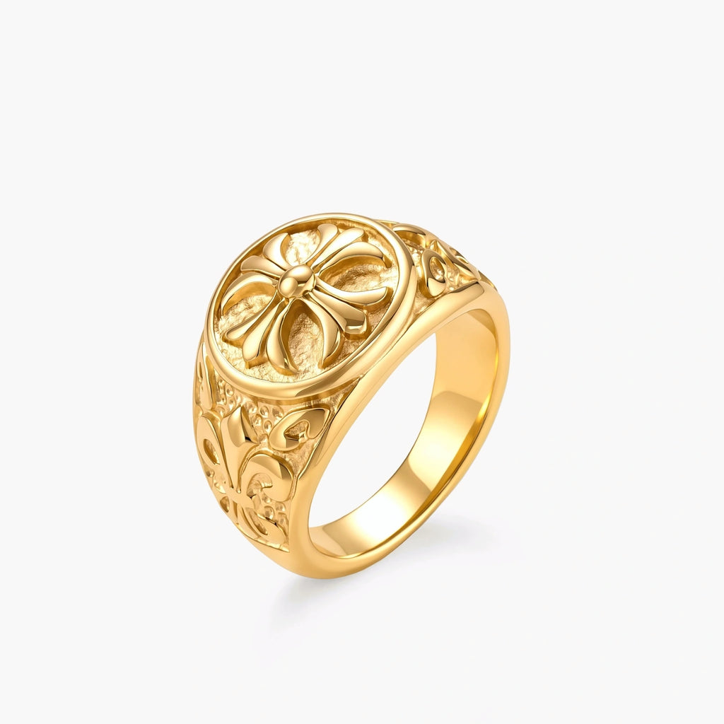 18K gold-plated stainless steel signet ring with ornate cross face and carved filigree scroll band, shown from three angles.