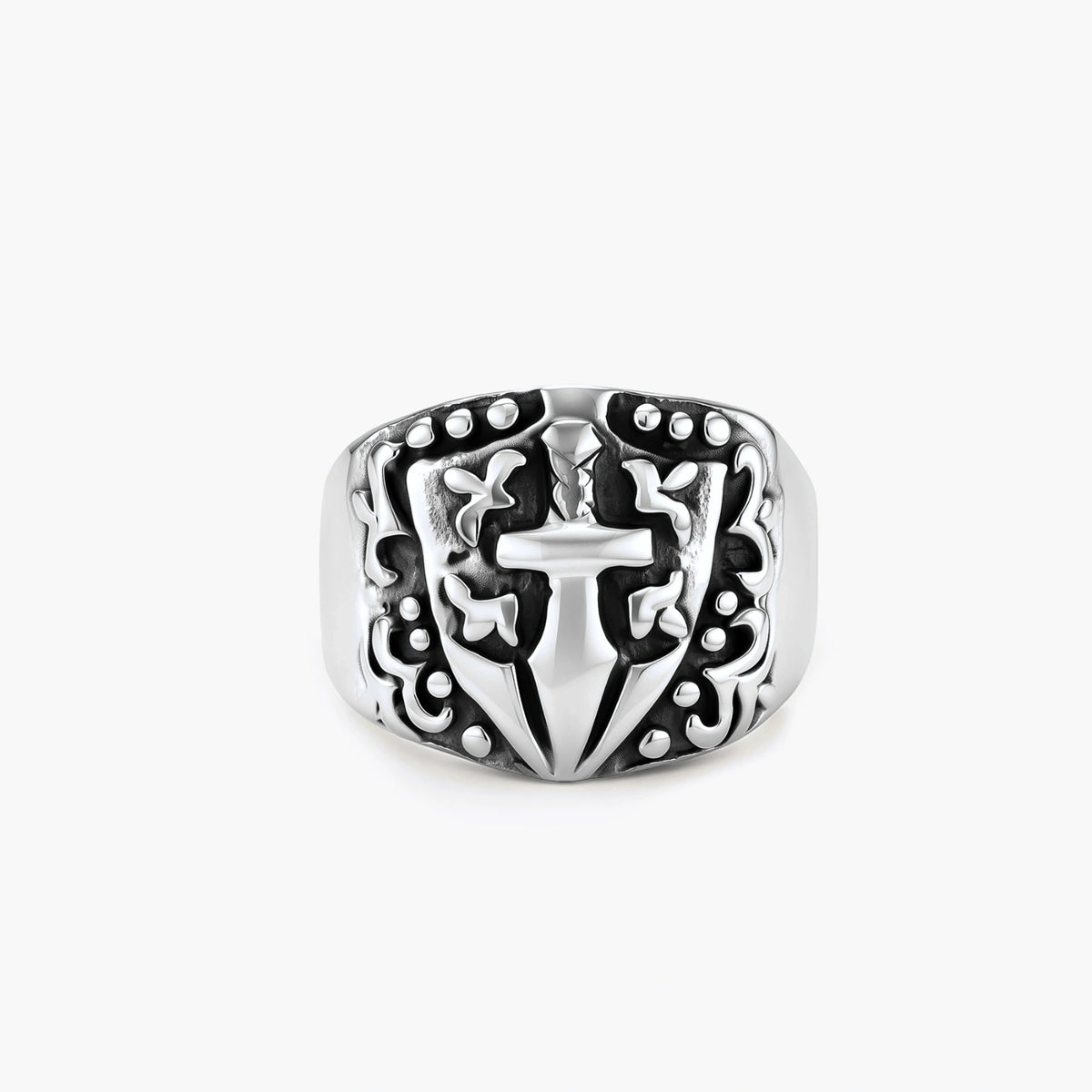 Silver 316L stainless steel men's signet ring with raised knight shield, cross motif, and ornate blackened scrollwork detailing.